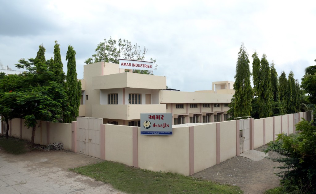 Amar Industries factory compound with wall and gate.